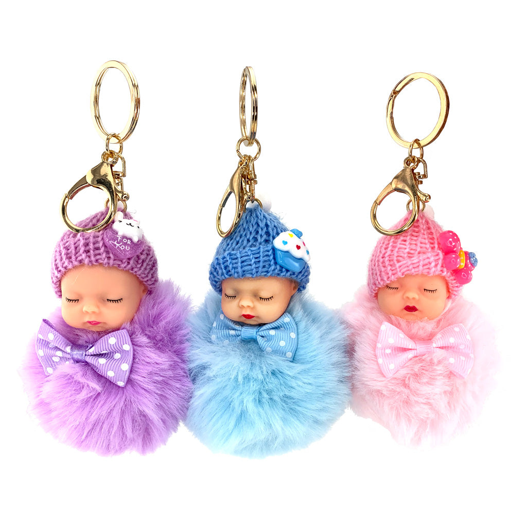 Sleepy Baby Keyrings with pom pom in purple, blue and pink with gold coloured hardware and chain
