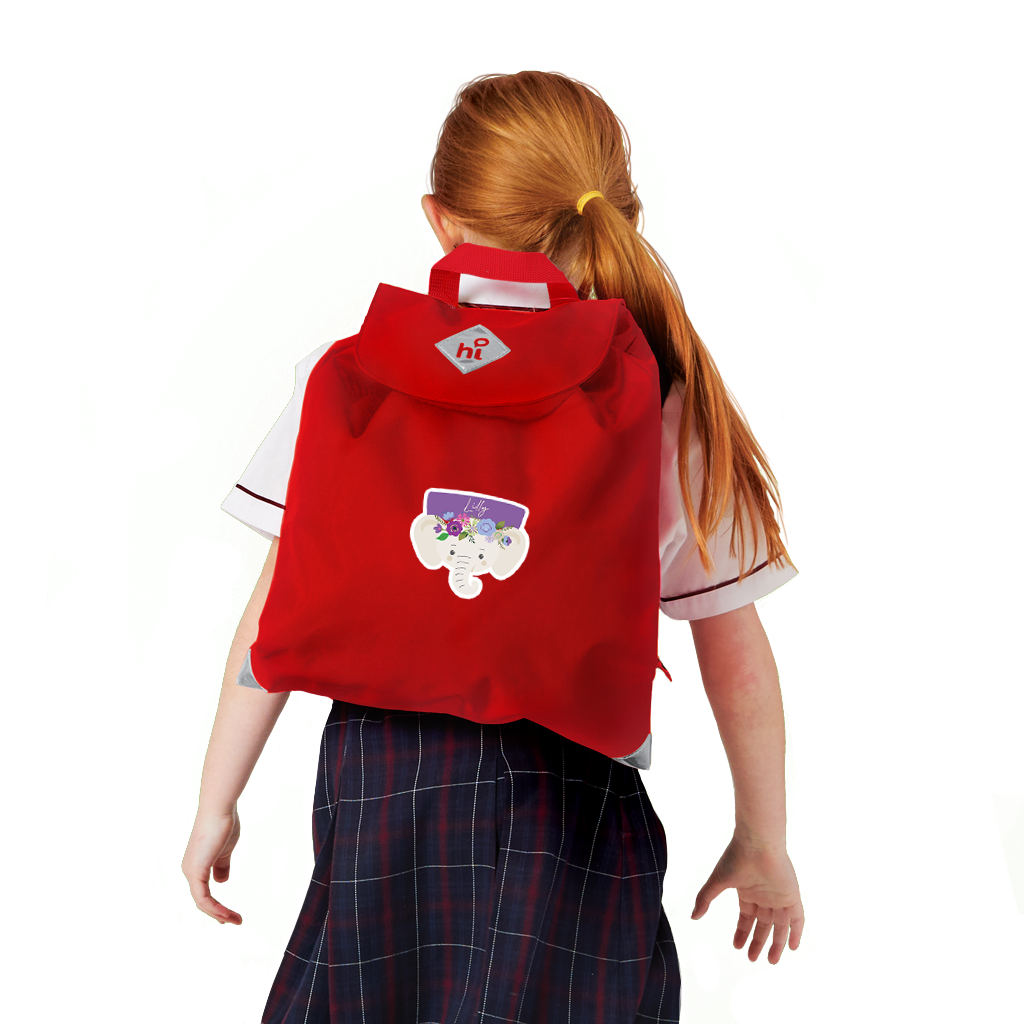 8 year old child model in school uniform wearing on her back the Harlequin Eco Excursion Bag in red with personalisation.