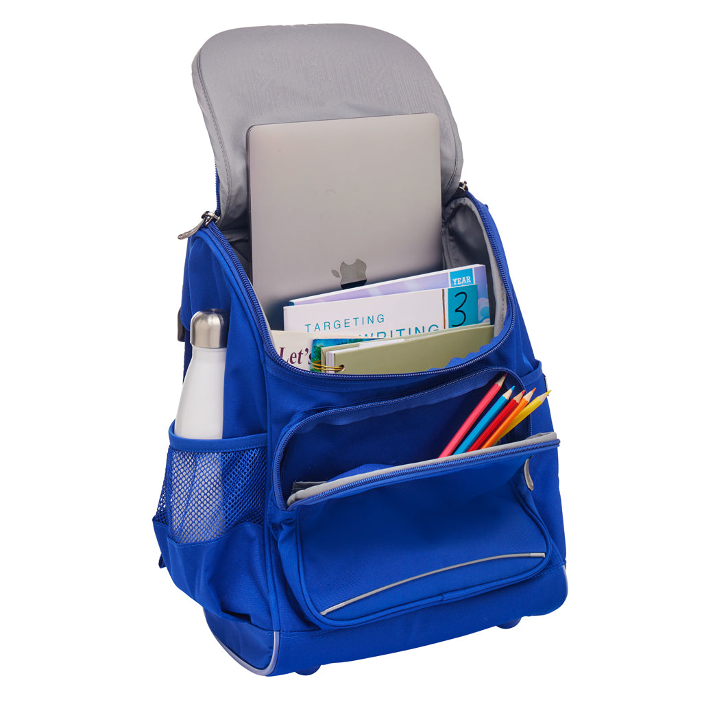 Inside view of a Royal blue Harlequin Mighty backpack. Showing the laptop pocket, internal compartment and the front pocket. The backpack has been packed with school books, a laptop, water bottle and coloured pencils.