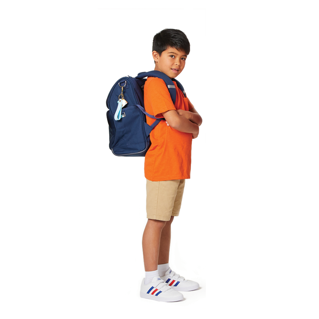 Seven year old boy wearing an orange t-shirt and a navy Harlequin Mighty Backpack.