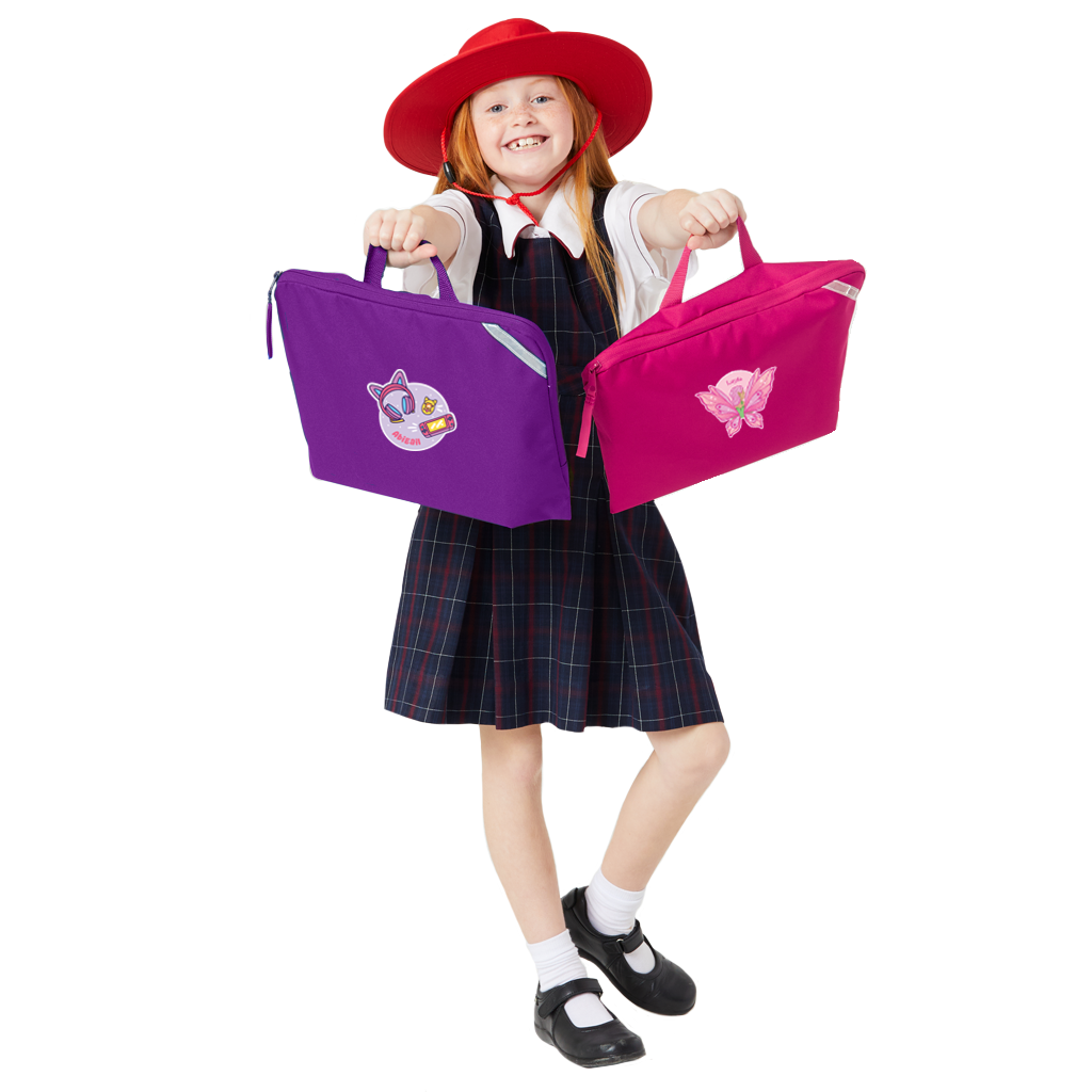 8 year old child model in school uniform holding up two Harlequin Quantum book bags. One is pink whilst the other is purple and they both have personalisation on them.