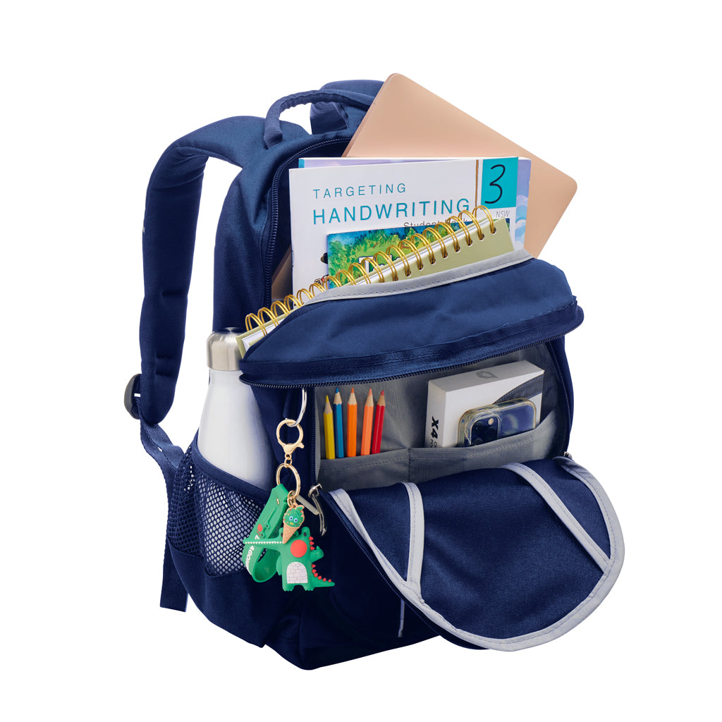 Fully open view of the Harlequin Study backpack in navy. Showing internal compartment and the front pocket. The backpack has been packed with school books, laptop, water bottle, phone and coloured pencils. The D-Ring has an animal keychain on it.