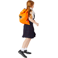 8 year old child model, in school uniform, walking past wearing the Harlequin VIVID Hi-Viz Excursion bag with personalisation on the bag.