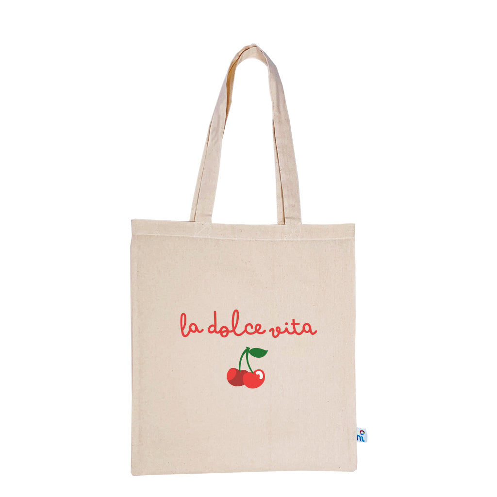 Harlequin Calico bag in natural colour displaying long shoulder handles with large La Dolce Vita Design in green