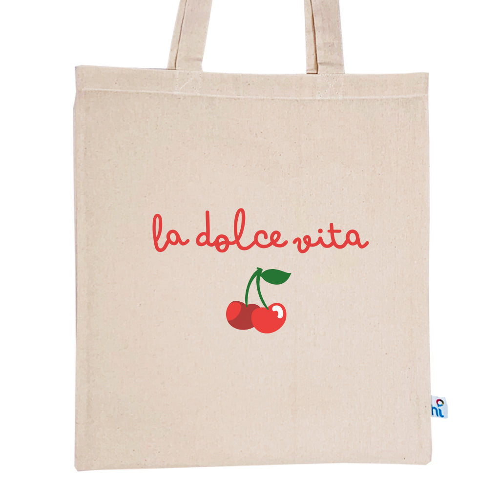Harlequin Calico bag in natural colour displaying long shoulder handles with large La Dolce Vita Design in green