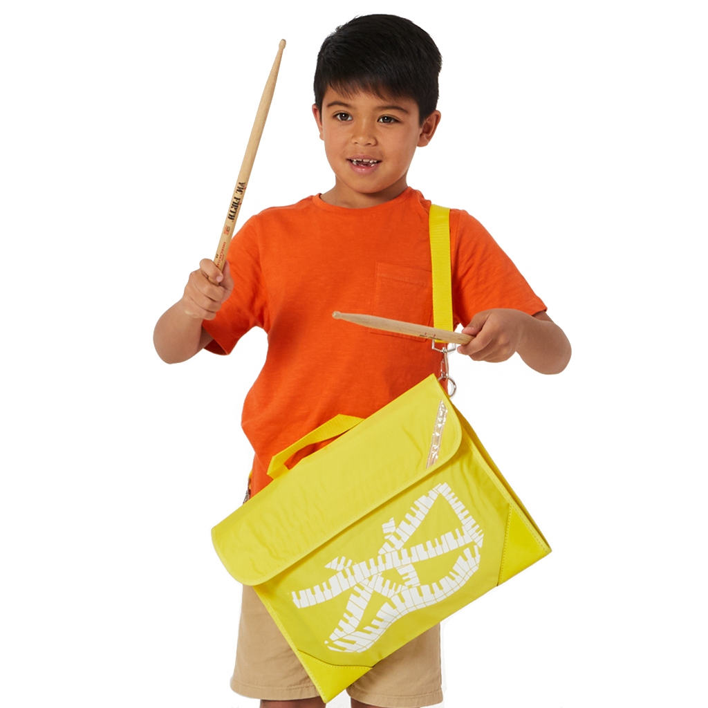 7 year old child model in casual clothing wearing across his left shoulder the Harlequin Quartet Keyboard Music bag in Yellow with a pre-printed with a Keyboard motif.