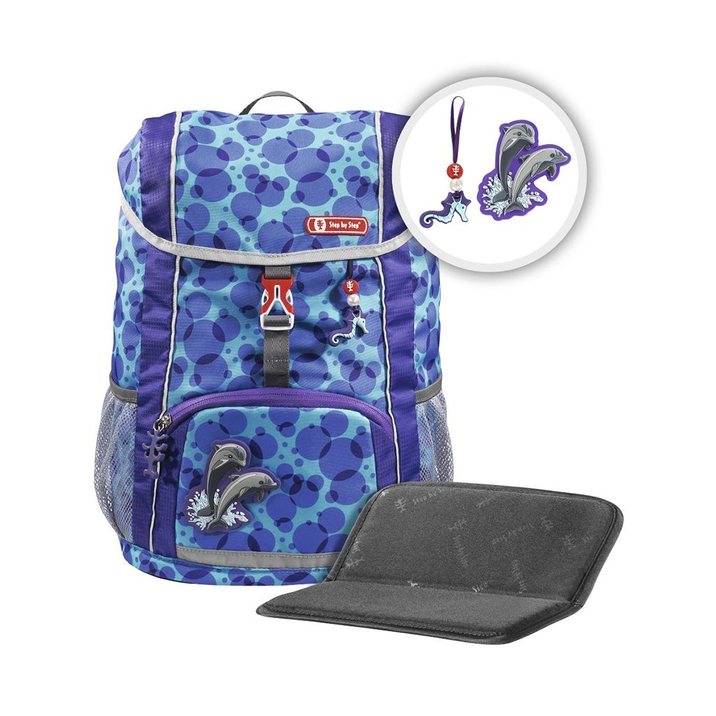 Blue and purple dot Step By Step backpack front angle view displaying a top pocket, a buckle clip and a seahorse chain with a front lower pocket at the bottom, showing two side water bottle holders, dolphin magnet and seat cushion