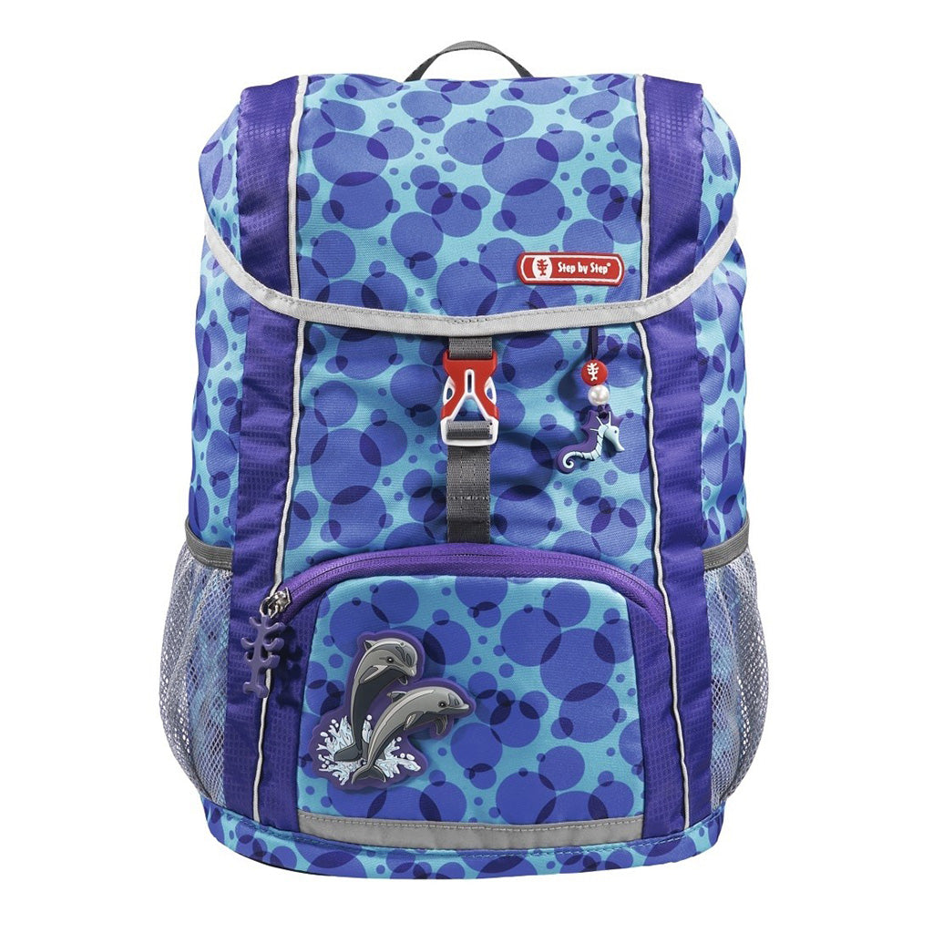 Blue and Purple dot Step By Step Junior Happy Dolphin backpack front angle view displaying a top pocket, a buckle clip and a seahorse chain with a front lower pocket at the bottom, magnetic dolphin and showing two side water bottle holders
