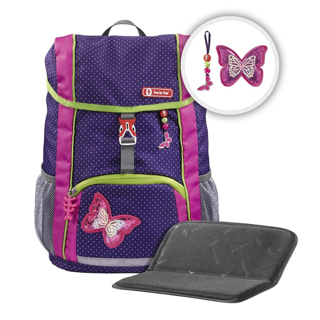 Purple pok-a-dot Step By Step backpack front angle view displaying a top pocket, a buckle clip and a butterfly chain with a front lower pocket at the bottom, showing two side water bottle holders, butterfly magnet and seat cushion