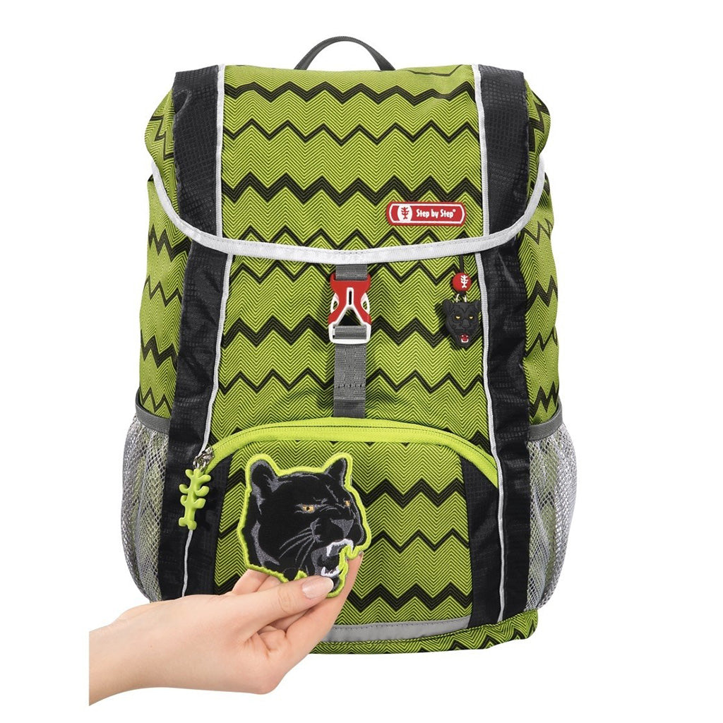Lime and Black Step By Step Wild cat backpack front angle view displaying a top pocket, a buckle clip and a wild cat chain with a front lower pocket at the bottom, two side water bottle holders, showcasing the magnetic wild cat