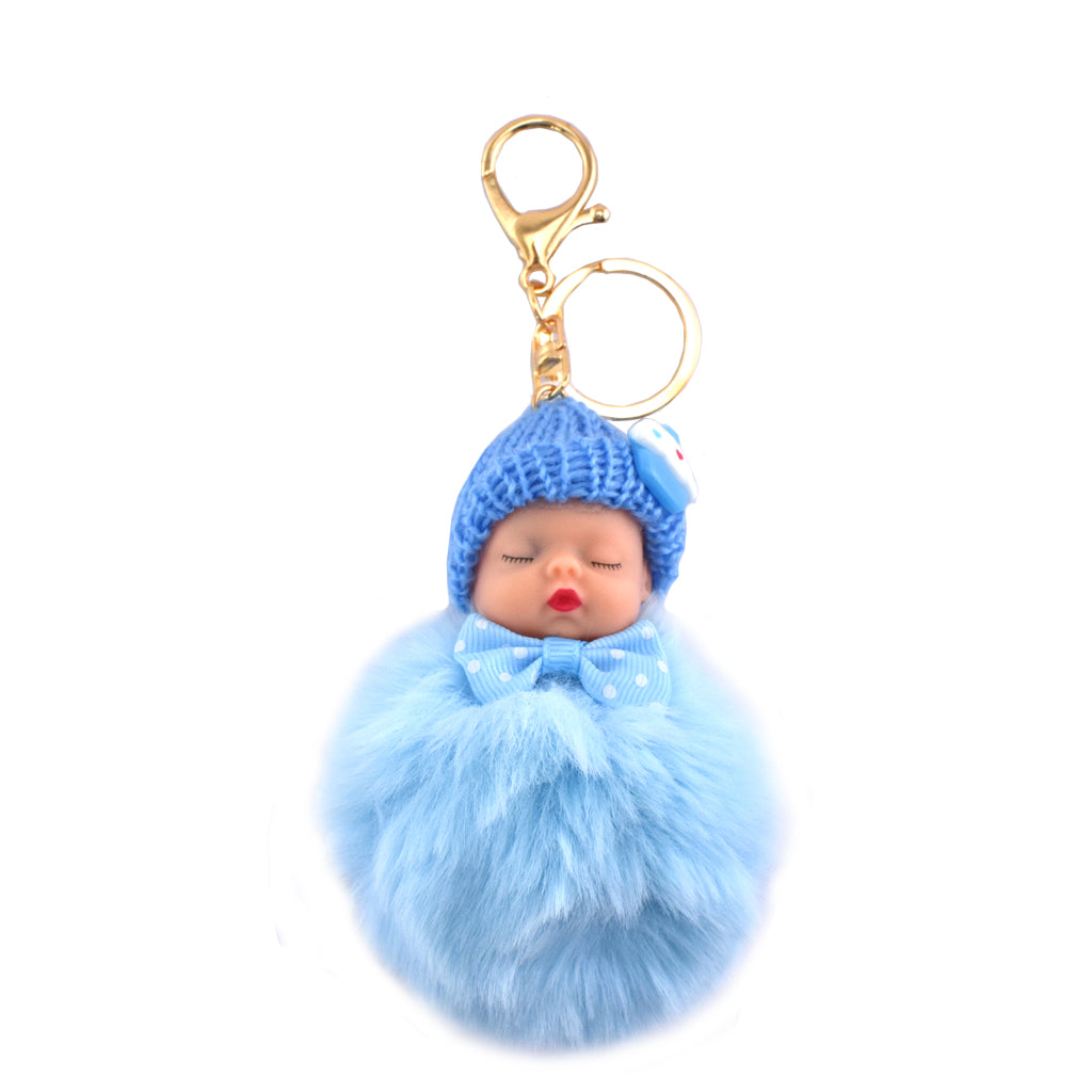 Blue baby-shaped keychain with fluffy body and knitted hat on a white background