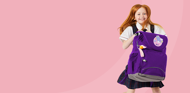 Girl with purple ergonomic Ergo school bag, backpack, jumping and smiling