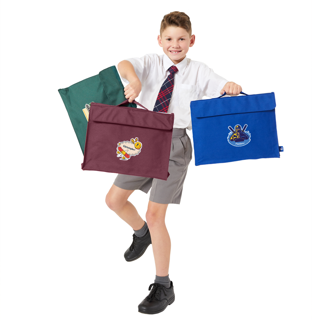 8 year old child model in school uniform holding up three Harlequin Premier Library bags in his hands. One is bottle green, one is maroon and the other is royal blue. They each have their own personalisation.