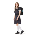 13 year old child model in school uniform wearing on her back the Harlequin Osteo Senior Backpack in black.