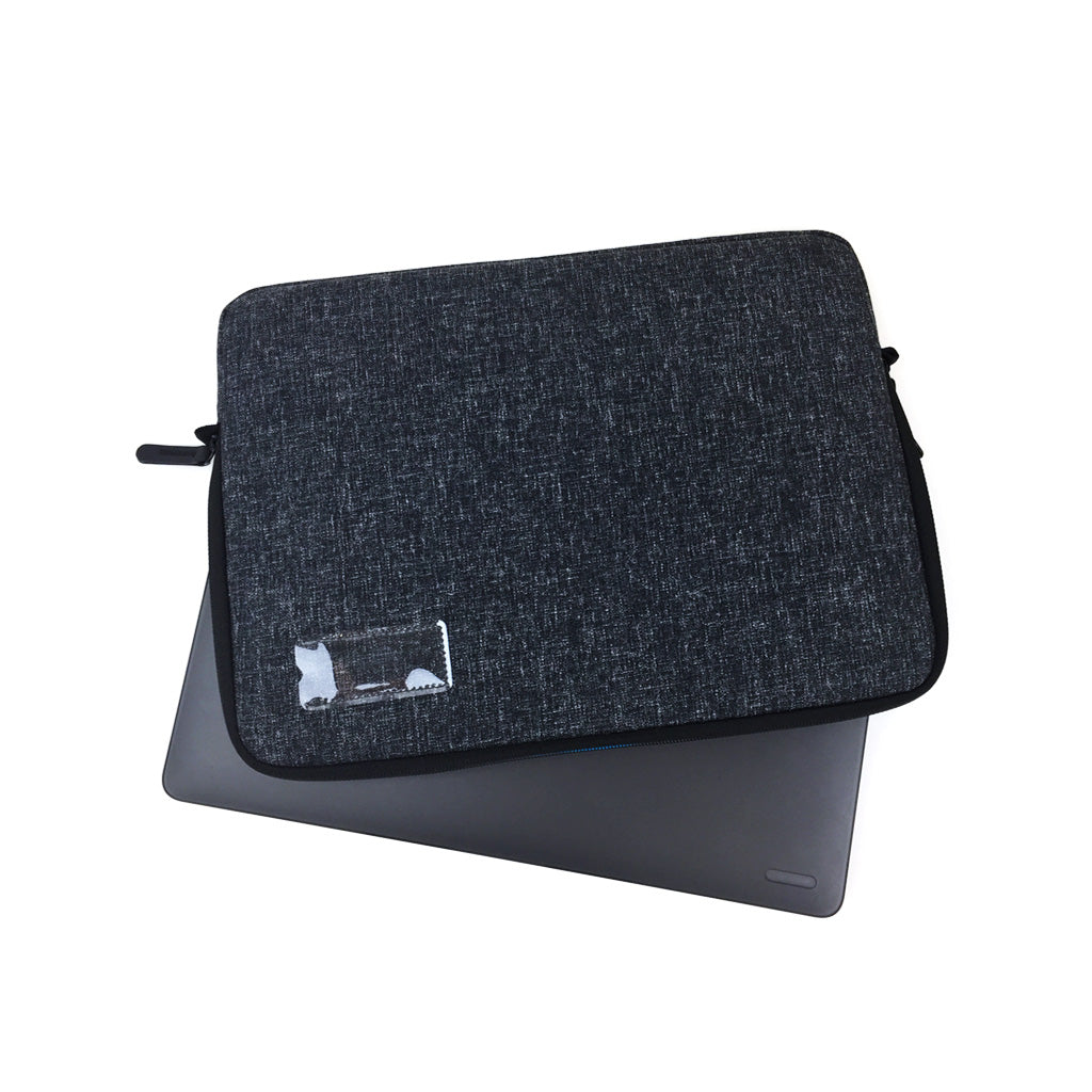 Back view of a black 13 inch laptop sleeve with a name card holder on reverse, shown with a laptop inside.