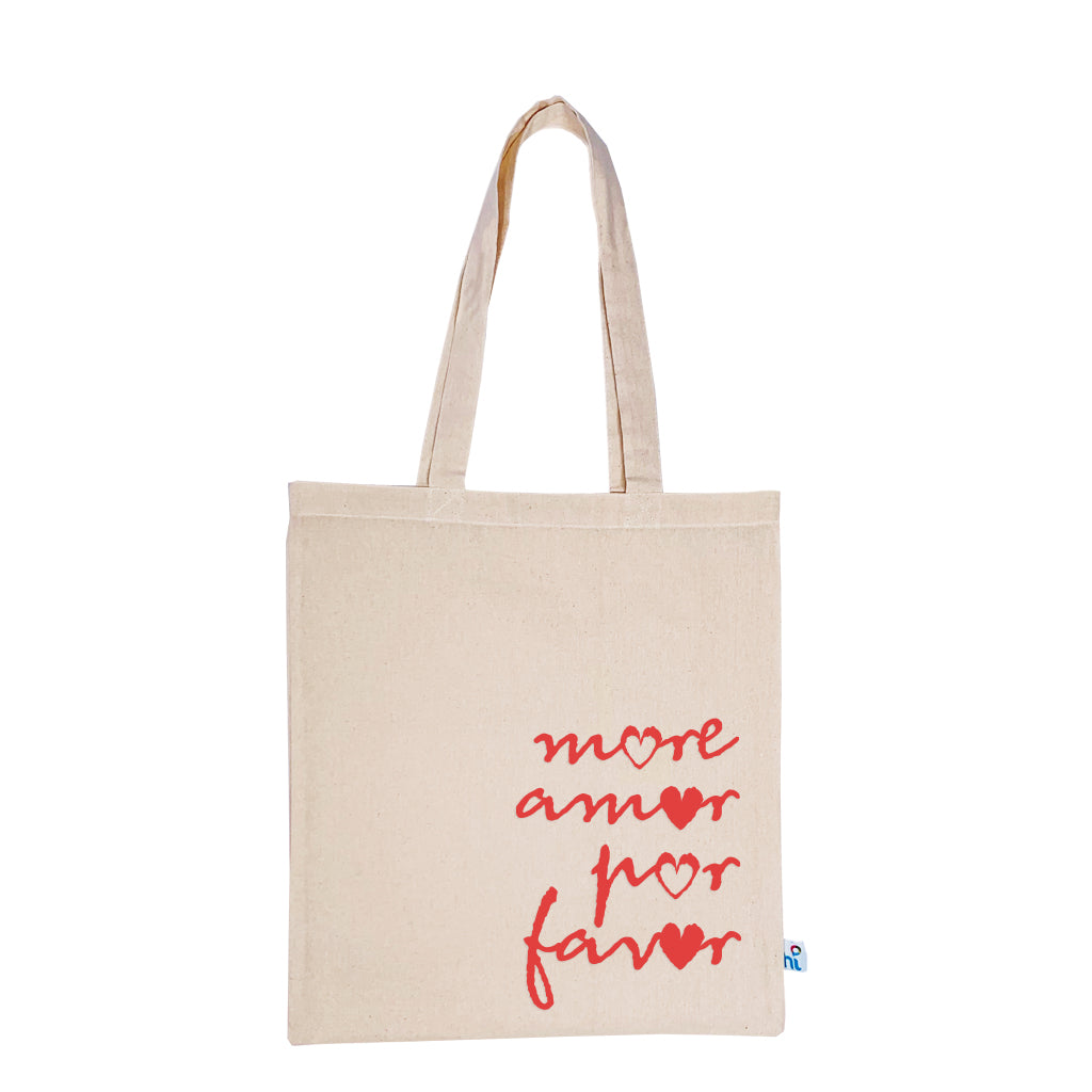 Harlequin Calico bag in natural colour displaying long shoulder handles with large More Amor Por Favor Design 