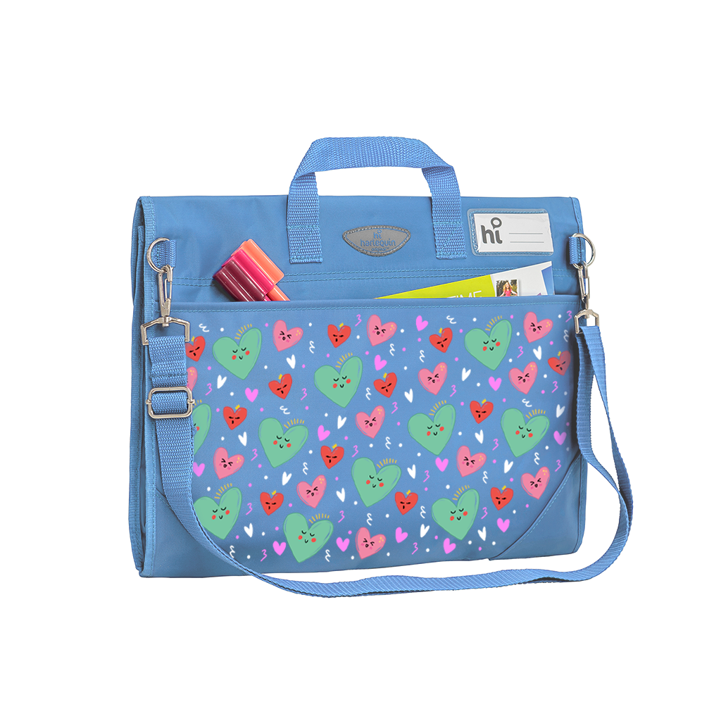 Harlequin Safety Library bag in Sky Blue with Sweet Hearts design from the Harlequin Creatix Signature Series. Back angle view displaying carry handle, D-Rings, name card sleeve, side pocket, reinforced corners and shoulder strap.