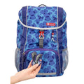Blue and Purple dot Step By Step Junior Happy Dolphin backpack front angle view displaying a top pocket, a buckle clip and a seahorse chain with a front lower pocket at the bottom,  two side water bottle holders, showcasing the magnetic dolphin