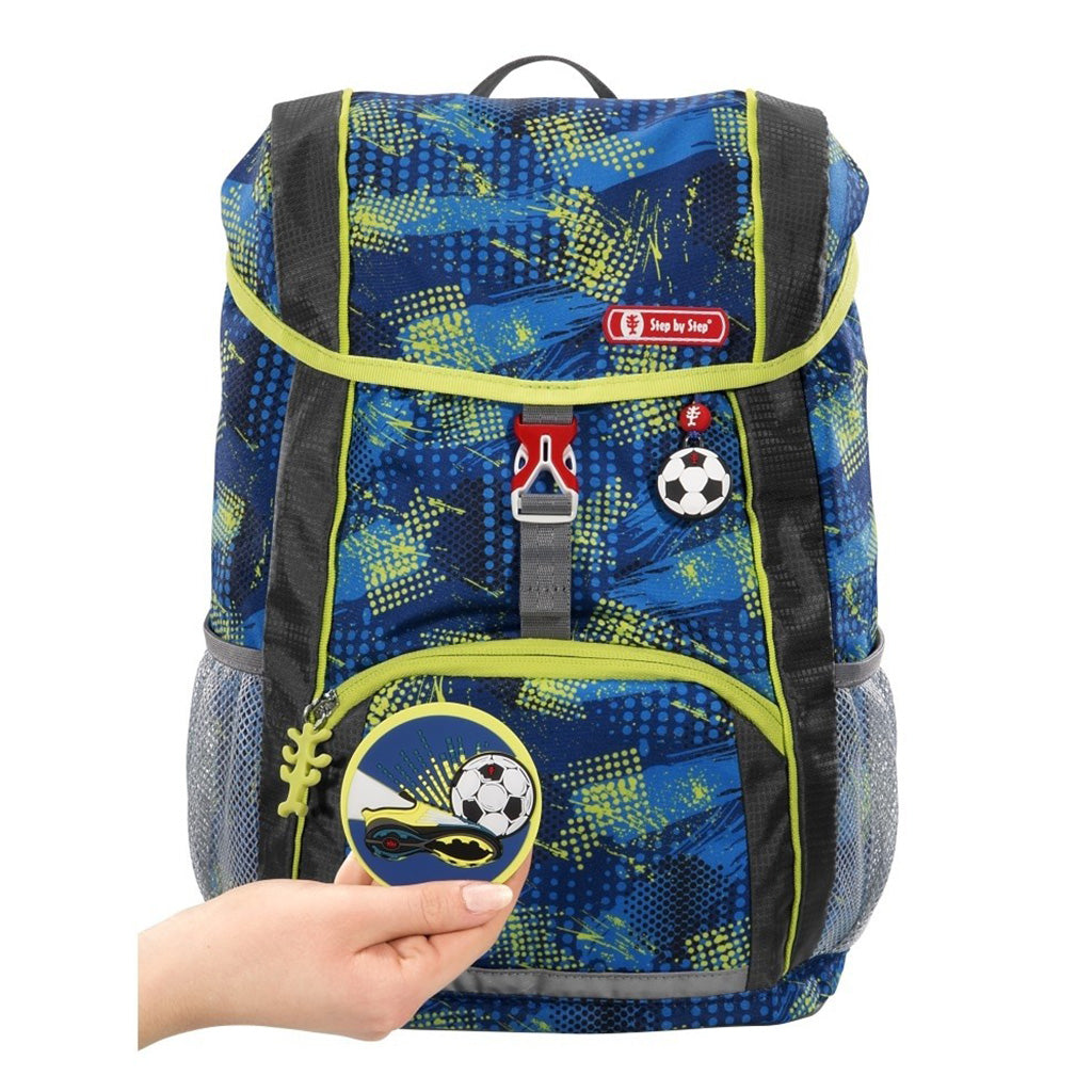Blue and Lime Step By Step Junior soccer backpack front angle view displaying a top pocket, a buckle clip and a soccer chain with a front lower pocket at the bottom, two side water bottle holders, showcasing the magnetic soccer ball